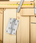 Stainless Steel Self Closing Automatic Return Door Hinges Spring Loaded Hidden Door Hardware on wooden background