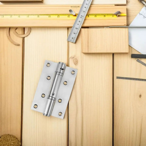 Stainless Steel Self Closing Automatic Return Door Hinges Spring Loaded Hidden Door Hardware on wooden background