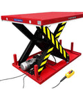 Heavy Duty Electric Hydraulic Scissor Lift Table With Beefy Steel Build And Massive 13200 Lb Capacity For The Garage Or Warehouse Easy Foot Pedal Lift, showing the red lift with safety stripes and controller.