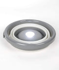 5 Liter Collapsible Flashlight Bucket With 200 Lumen Removable Magnetic Puck Light, folded view, white and gray material.