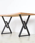 Heavy Duty Metal Table Legs 2 Pack 28 Inch High 20 Inch Wide Square Tube Iron Desk Legs Rustic Industrial Country Style For Dining Tables Office Desks supporting a wooden tabletop in a modern setting.
