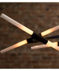Modern Iron Pendant Light With Herringbone Pattern Dimmable LED Hanging Lamp For Contemporary Living And Dining Spaces Featuring Solid Black Frame, illuminated glass rods on a black frame.
