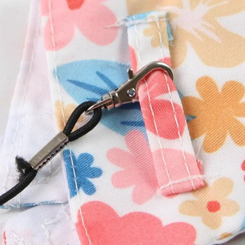 Close-up of floral fabric and clip of the Anti Pinch Design Bird Flight Suit For Parrots Adjustable Walking Harness And Training Gear