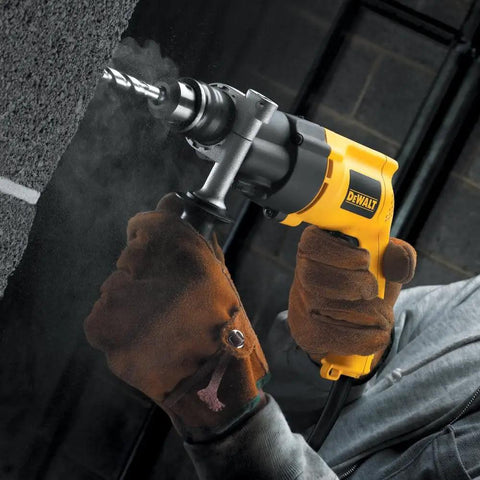 Power Through Concrete And Wood With A 1/2 Inch Hammer Drill, 7.8 Amp Heavy Duty, dual range gear in use on a concrete wall