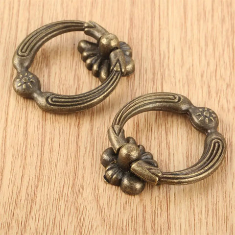 Two zinc alloy antique bronze drawer handles on wood surface for jewelry boxes and DIY projects, easy install with screws.
