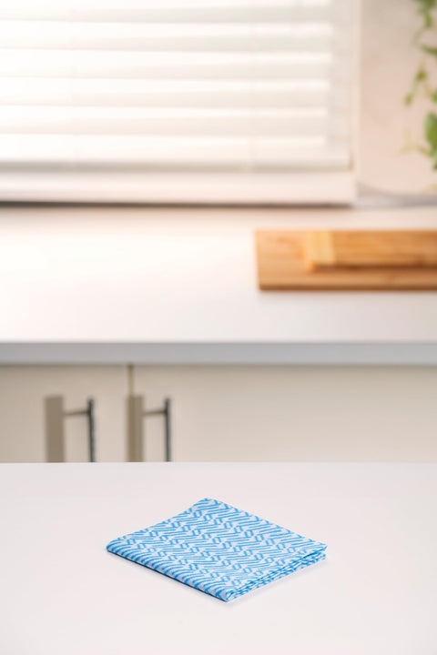 Reusable Kitchen Wipes, 60 Count, Rinse and Reuse Up to 10 Times on a kitchen counter with window and cutting board in background.