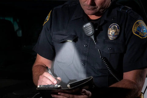 Police officer using White LITE Hands Free LED Pocket Light With USB Rechargeable Power, clip-on uniform, nighttime writing