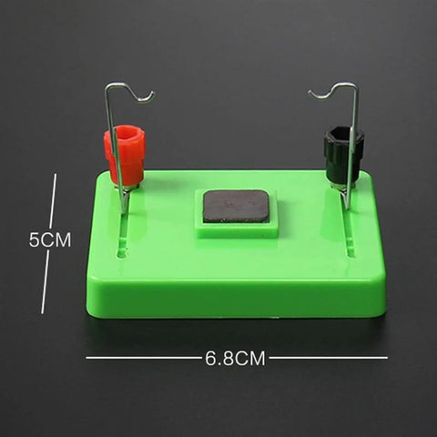 Green base of Electric Motor Model And Electromagnetic Swing Kit For Classroom Learning with metal connectors.