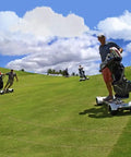 Men riding Electric Four Wheel Folding Golf Cart Skateboard Trolley on a golf course with golf bags, showcasing mobility and fun.