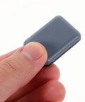 Hand holding a single slider from 12 Pack PTFE Furniture Sliders For Chairs And Stools With Adhesive Pads, Quiet Glide Floor Protectors