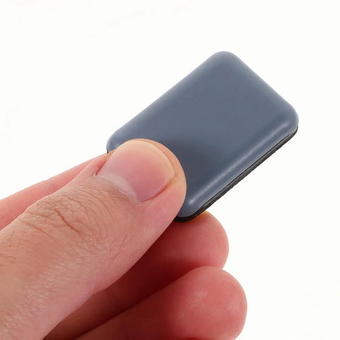 Hand holding a single slider from 12 Pack PTFE Furniture Sliders For Chairs And Stools With Adhesive Pads, Quiet Glide Floor Protectors