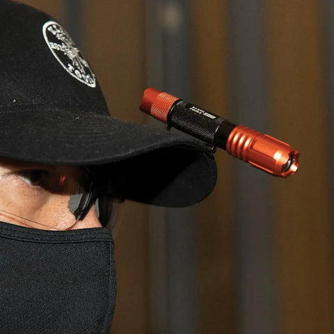 Rechargeable Pocket Flashlight With Dual-Direction Clip, 275 Lumen High Power, mounted on a cap with a person wearing a mask