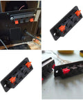 10 Pack 4 Pin Speaker Terminal Blocks With Spring Clips For DIY Audio, shown installed and in side view on a table.