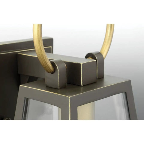 Close-up of Barnett Outdoor One Light Wall Lantern In Antique Bronze Finish, showcasing metal and clear glass design.