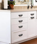 Installed white kitchen cabinets with Six Pack Black Cabinet Cup Pulls And Drawer Handles, zinc alloy, 128mm center distance.