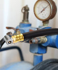 Solid Brass Short Air Compressor Hose Two Pack 18 Inch With One Quarter Inch Male NPT Threads attached to compressor.