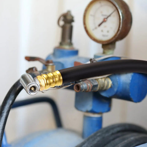 Solid Brass Short Air Compressor Hose Two Pack 18 Inch With One Quarter Inch Male NPT Threads attached to compressor.
