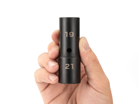 Close-up of hand holding 1/2 Inch Drive Flip Socket 19 x 21 mm Deep Thin Wall Impact Socket For Wheel Service With Reversible Flip Design