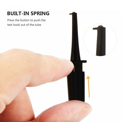Close-up of a black insulated test hook probe with a built-in spring and finger pressing, part of Test Hook Probe Kit For Digital Multimeter Leads With Safe Insulated Plastic Boots Round Test Hooks And Mini Clips That Grip Tiny Components Tight Powerful Spring Tension Keeps Contacts Secure And Short Free.