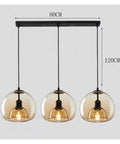 Modern Dine Dining Room Pendant Lights Indoor Lighting Ceiling Lamp Hanging Light Led Chandeliers for Living Room, features three round amber glass globes.