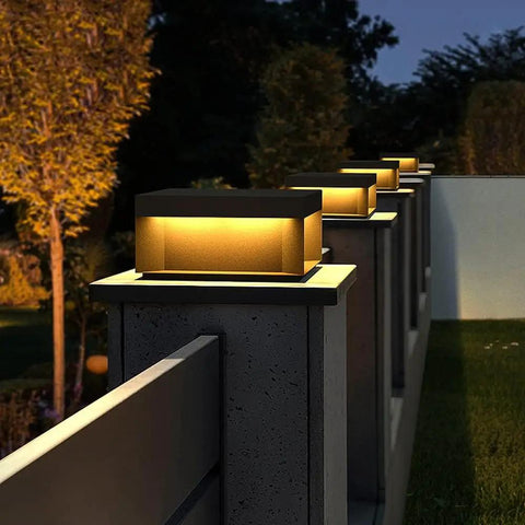 Outdoor Square Post Lights 11 Inch Dope Pillar Lamps Built Tough From Die Cast Aluminum Waterproof LED Path Lighting For Patio Fence Gate Deck Park Entrance Yard Decor glowing on a fence.