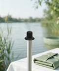 Heavy Duty Black Plastic Umbrella End Caps With Threaded Spiral Finials Perfect For Patio Repair And Keeping Outdoor Gear Looking Fresh Ready For Backyard Fun Or Beach Vibes During Summer Months, black plastic umbrella cap on pole by lakeside