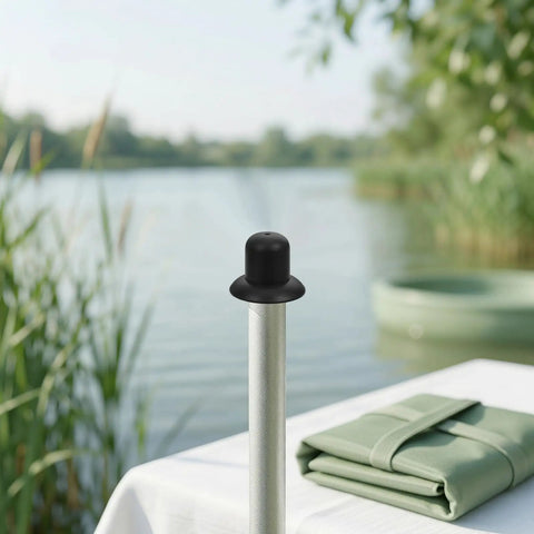 Heavy Duty Black Plastic Umbrella End Caps With Threaded Spiral Finials Perfect For Patio Repair And Keeping Outdoor Gear Looking Fresh Ready For Backyard Fun Or Beach Vibes During Summer Months, black plastic umbrella cap on pole by lakeside