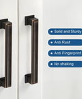 Oil Rubbed Bronze Cabinet Pulls 10 Pack 5 Inch Hole Center Heavy Duty Kitchen And Furniture Handles installed on white cabinet door