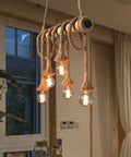 Five Heads Vintage Bamboo Chandelier With Hemp Rope Pendant Light Fixture hanging in a cozy room with Edison glow bulbs.