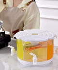 Five Point Five Liter Rotating Beverage Dispenser With Four Separate Compartments And Dripless Spigot showcasing drinks and spouts on a countertop.