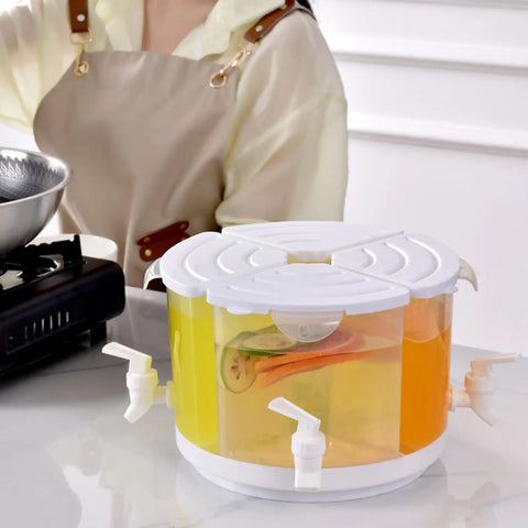 Five Point Five Liter Rotating Beverage Dispenser With Four Separate Compartments And Dripless Spigot showcasing drinks and spouts on a countertop.