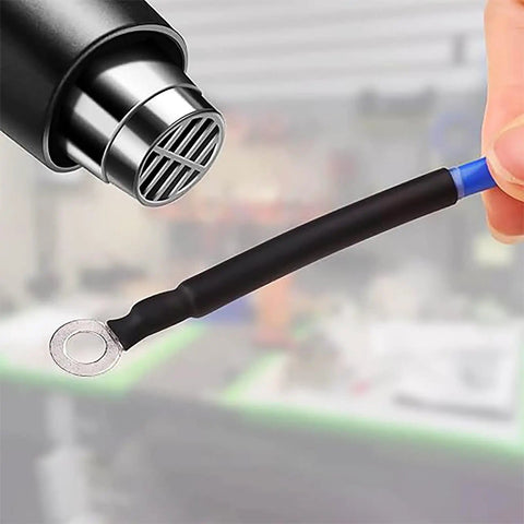 Applying heat to wire with black Heat Shrink Tubing Kit 328 Piece Assortment For Electrical Insulation And Wire Protection Black Red Sleeving