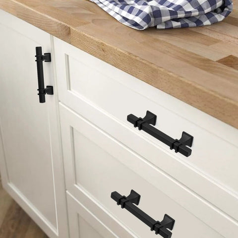 10 Pack 3 Inch Matte Black Cabinet Pulls With Solid Steel Construction And Zinc Alloy Base installed on white kitchen cabinets