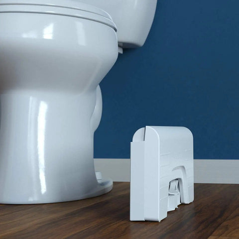 Fold N Stow Compact Foldable Toilet Stool White 8 Inch Space Saving Design folded beside white toilet on wooden floor