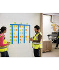 Workers using Extreme Adhesive Orange Sticky Notes 3x3 Inches for rugged jobsites on a wall with blue tape in a warehouse.