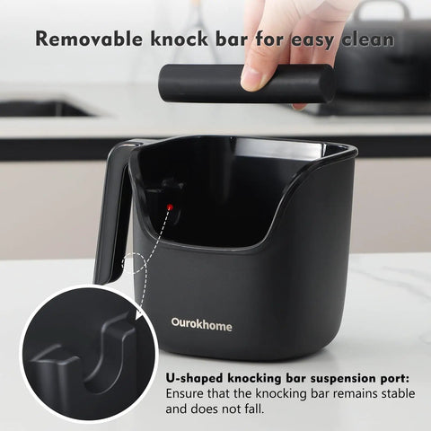 Black knock box for espresso grounds, pro-grade stainless steel barista tool with removable knock bar, handle and lid.