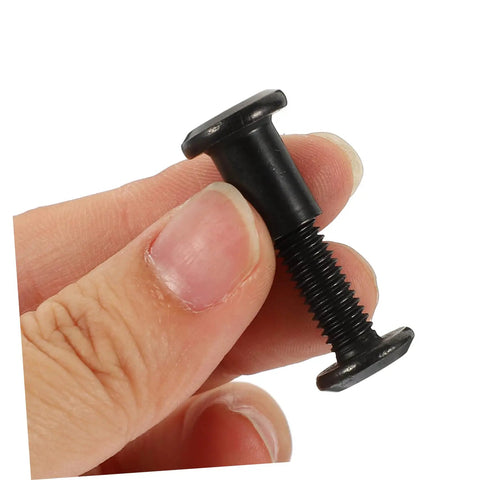 M6x25 Black Stainless Steel Binding Screws With Hex Socket barrel nut held in hand for furniture assembly or crafting use.