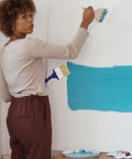 Person using Adjustable 3 Inch Paint Brush With 270 Degree Angled Head And 2.6 Cm Aperture on a wall