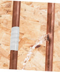 Peel And Stick Leak Repair Tape For Plumbers Rubberized Seam Tape applied to copper pipe with water leak fixed
