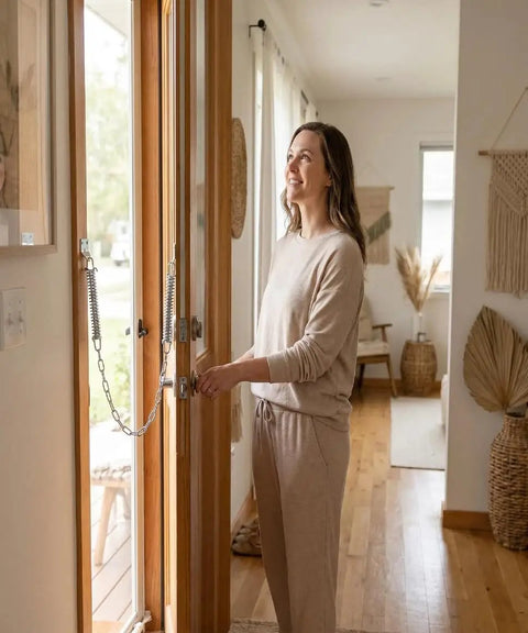 Woman using Built Tough Screen Door Chain Stopper With Spring, 2 Pack Wind Safety Hardware For Front Entry, Prevents Over Opening And Door Damage, Durable Spring Steel, Indoor Outdoor Use, Compatible With Storm Door Closer K 5026 on wood door