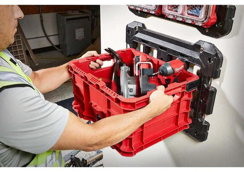 Person installing red Packout Compatible Tool Storage Crate Built Tough With Impact Resistant Polymer 50 Lb Capacity For Milwaukee PACKOUT System