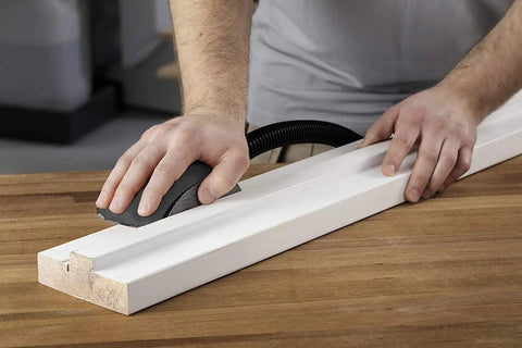 Dust Free Roundy Hand Sanding Block Kit With 6 Inch Sandpaper Discs Hook And Loop Abranet Mesh Discs held by user on wood surface