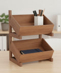 Straight Up Solid Wood Two Tier Storage Shelf With Angled Trays, Warm Brown Floor Stand Organizer on table holding pens and a notebook.