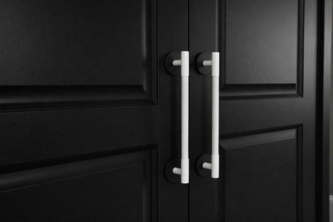 Matte Black Escutcheon Back Plates For Cabinet Knobs And Doors Four Pack Round Rosette Plate Two And One Third Inch Heavy Duty Die Cast Zinc Ideal For Bifold Closet Doors Door Pulls And Handles installed on black cabinet