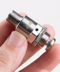 Close-up of Tac-3P Pneumatic Valve With Push Button Switch, compact metal design, M5x0.8 connection, held in fingers.