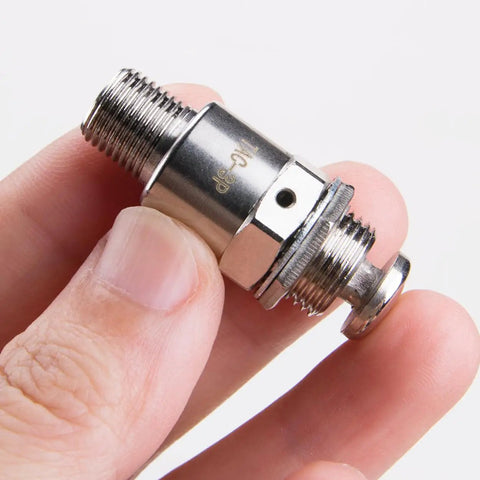 Close-up of Tac-3P Pneumatic Valve With Push Button Switch, compact metal design, M5x0.8 connection, held in fingers.
