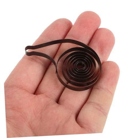 4 Pack Steel Clock Main Springs For Mechanical Clocks Replacement Parts held in hand for size reference