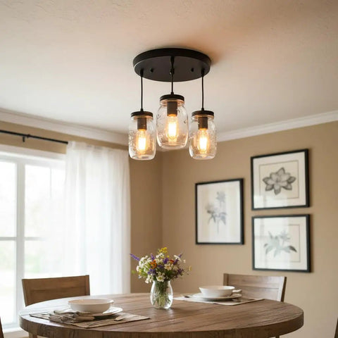 Industrial Mason Jar Pendant Lights for Kitchen Island above dining table with flowers, modern farmhouse style.