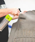 Person spraying All In One Car And Workshop Universal Cleaner Highly Concentrated And Dilutable Safe on a floor mat