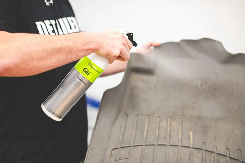 Person spraying All In One Car And Workshop Universal Cleaner Highly Concentrated And Dilutable Safe on a floor mat